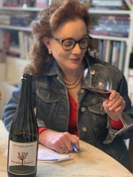 woman drinking a glass of venturini baldini lambrusco wine